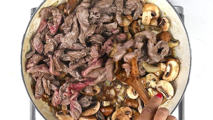 pan frying beef, mushrooms and onions in a shallow casserole