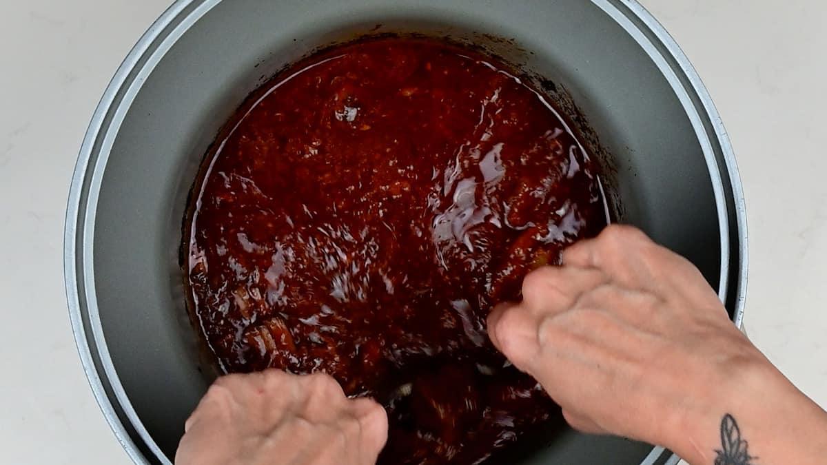 shredding slow cooked beef using two forks