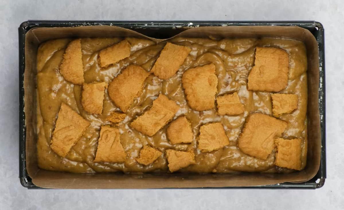 banana bread with biscoff cookie butter spread in a loaf tin ready for the oven