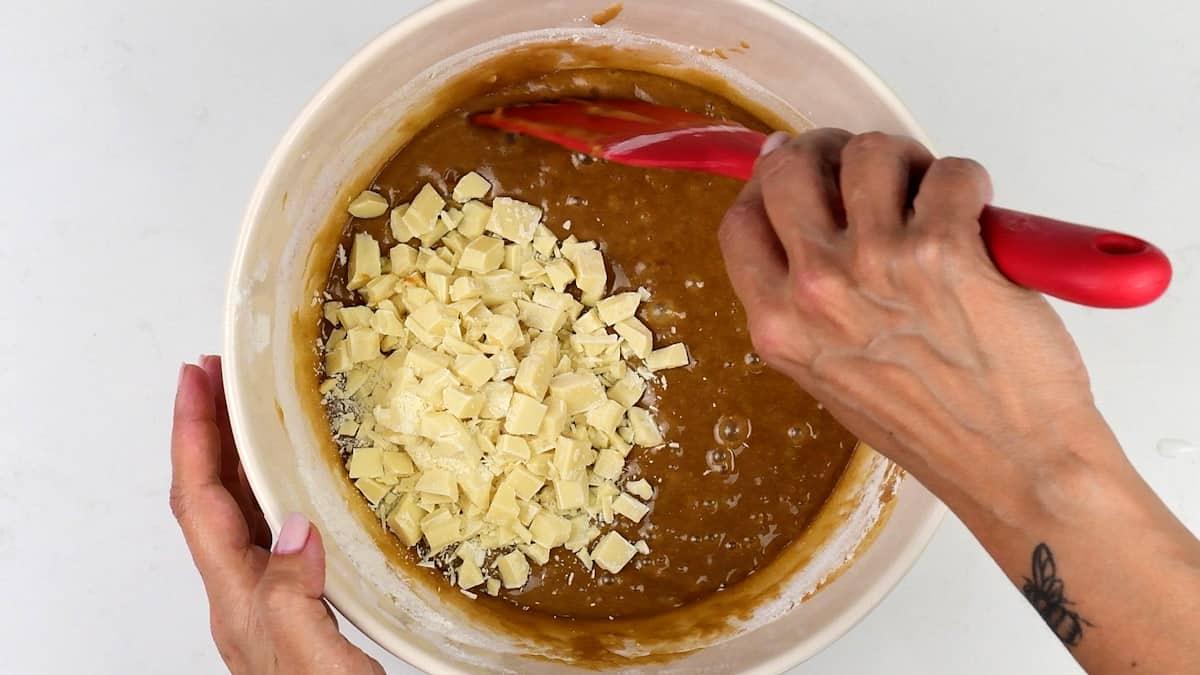 stirring white chocolate into blondie batter