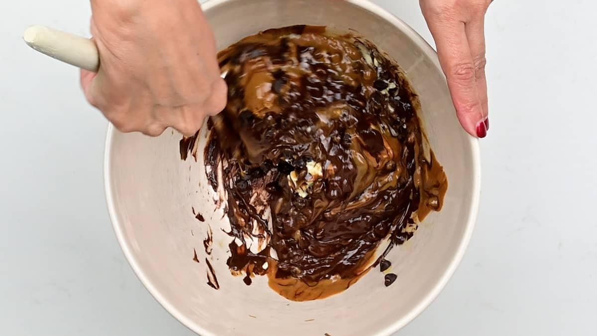 Stirring melted chocolate, Biscoff spread and butter together