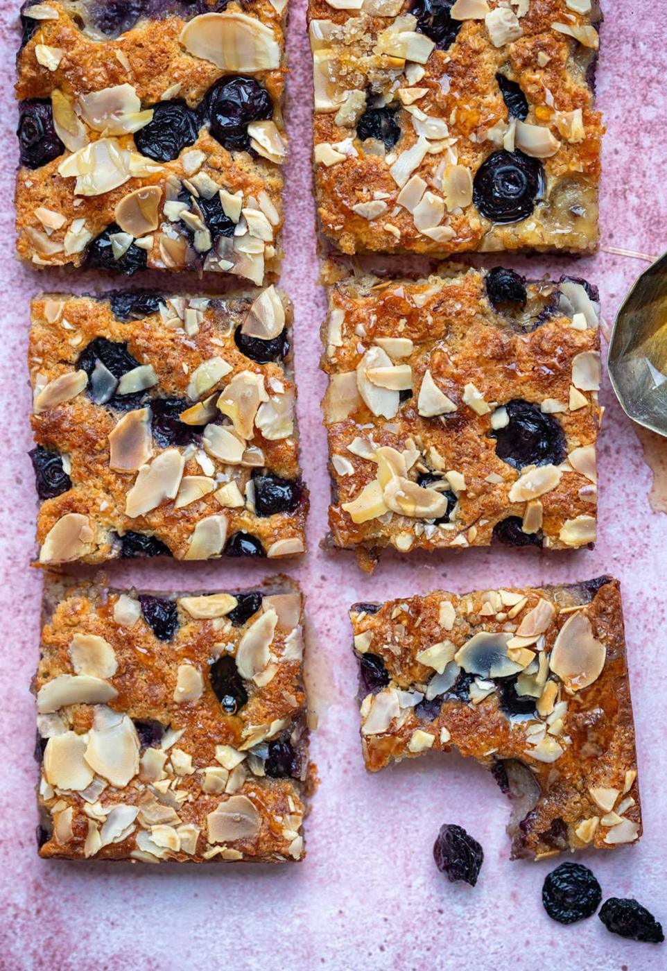 Blueberry cottage cheese breakfast bake, sliced, against a pink background