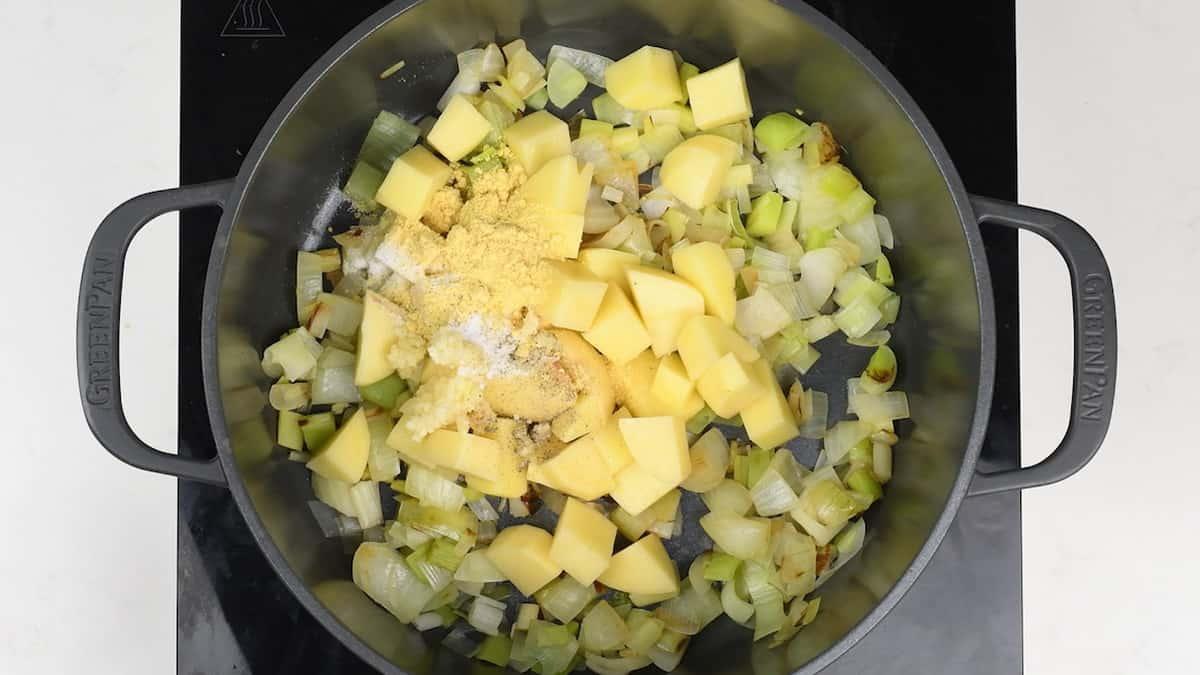 Potatoes and vegetables in pot prepping for broccoli soup