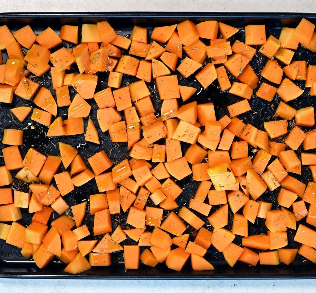 cubed butternut squash on a baking tray