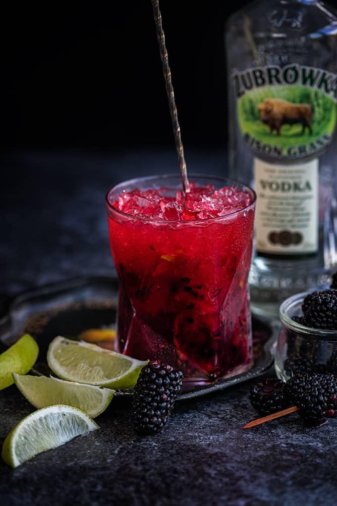Glass of Caipiroska on the rocks made with blackberries vodka