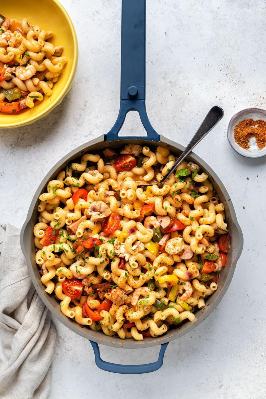 Cajun Jambalaya pasta with chicken, sausage, shrimp and vegetables in a chef's pan, overhead view