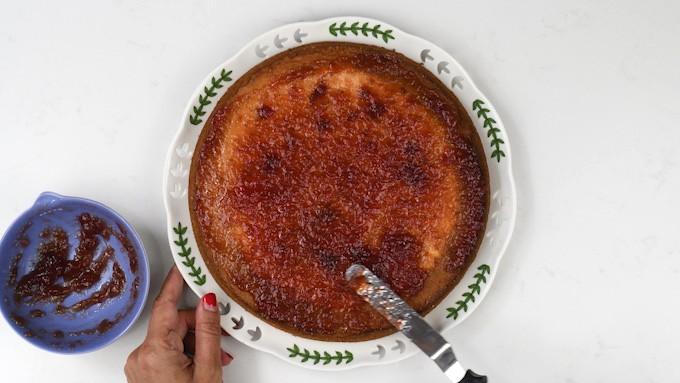 Spreading Victoria Sandwich cake with raspberry jam