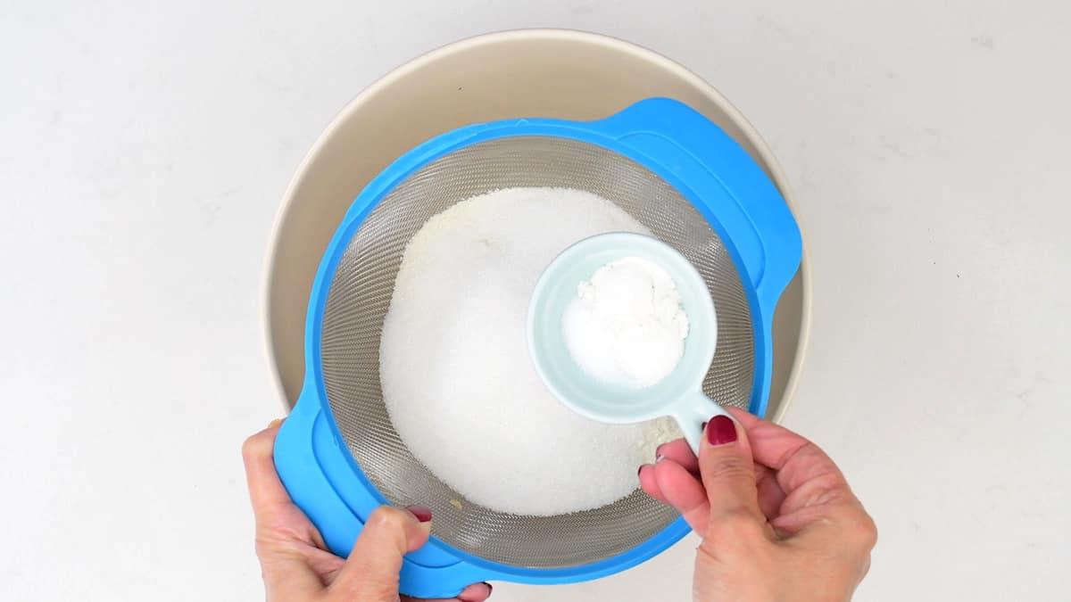 sifting flour sugar and baking powder into a bowl