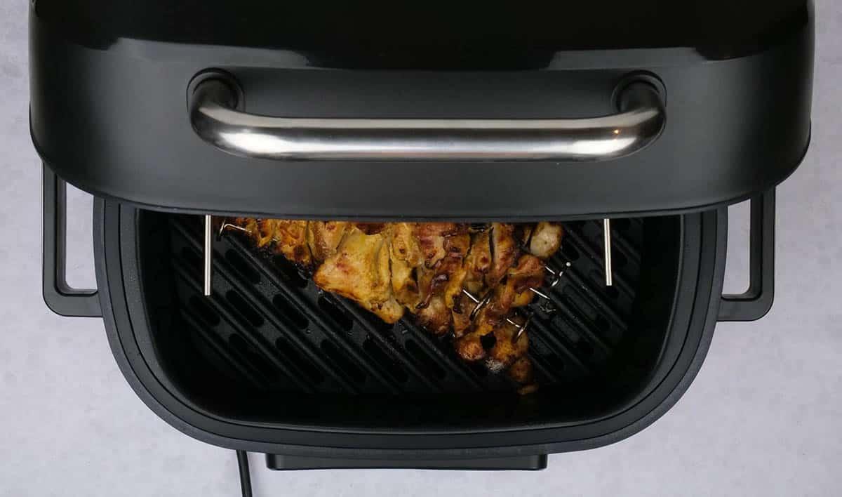 cooking chicken sharwama in an indoor grill