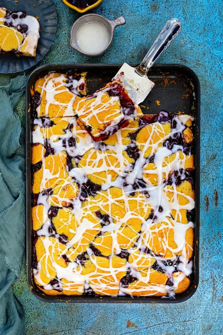Cherry Pie Bars in a large baking tray with slice cut out