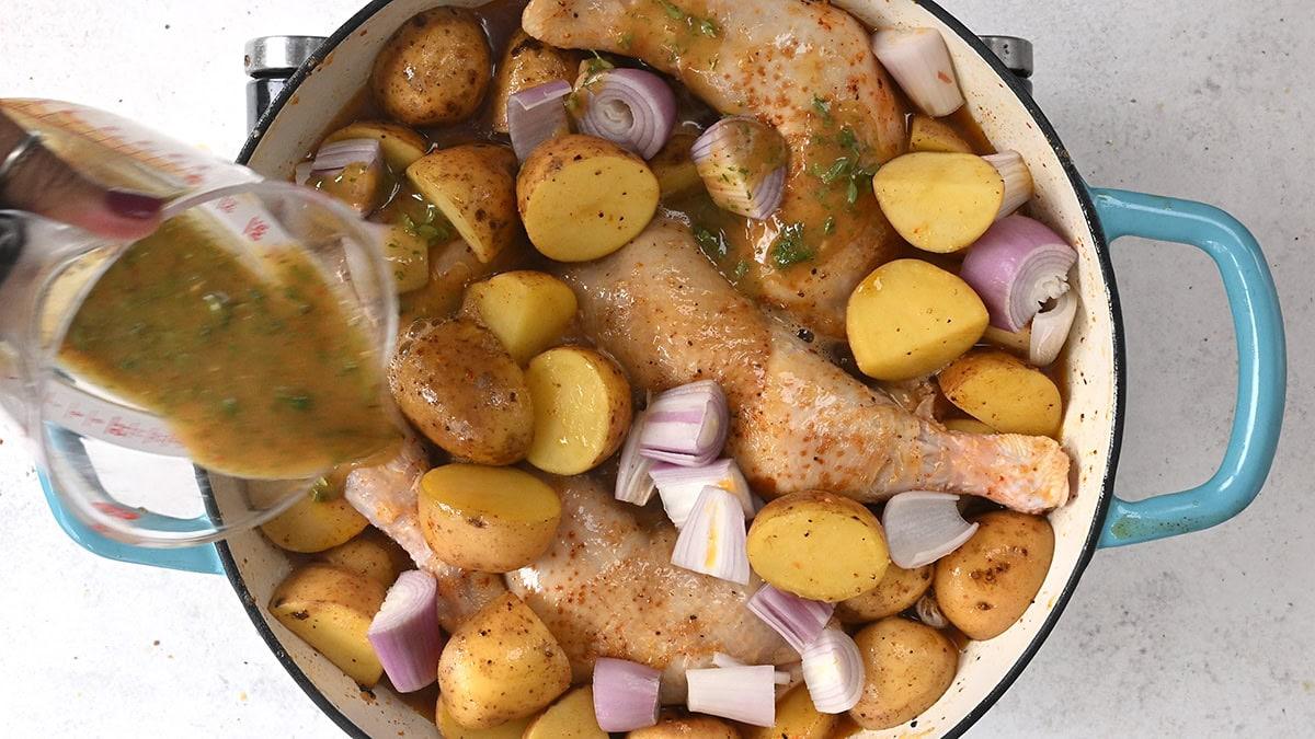 drizzling chicken legs and potatoes with a honey mustard marinade