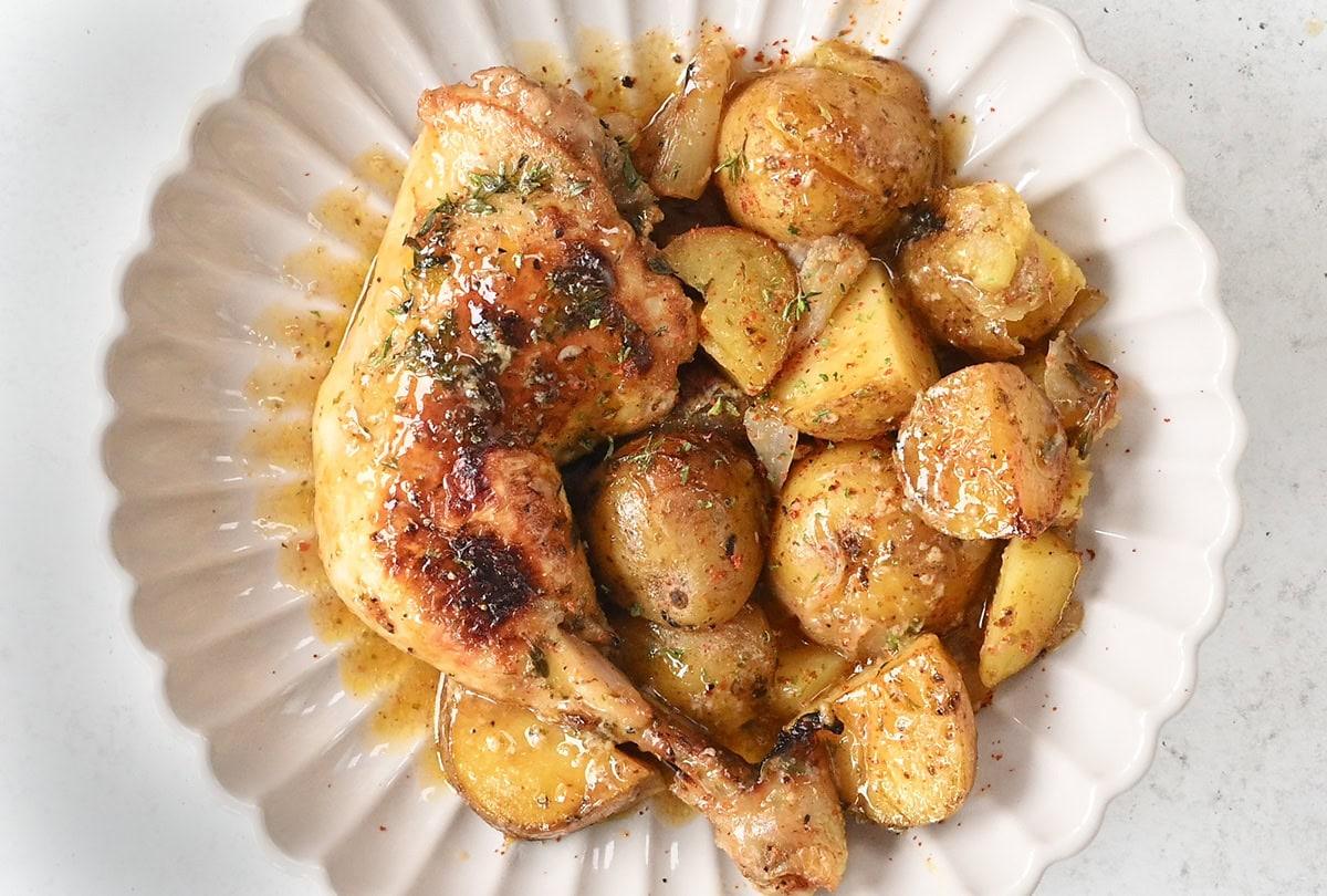 chicken and potatoes in a scalloped bowl