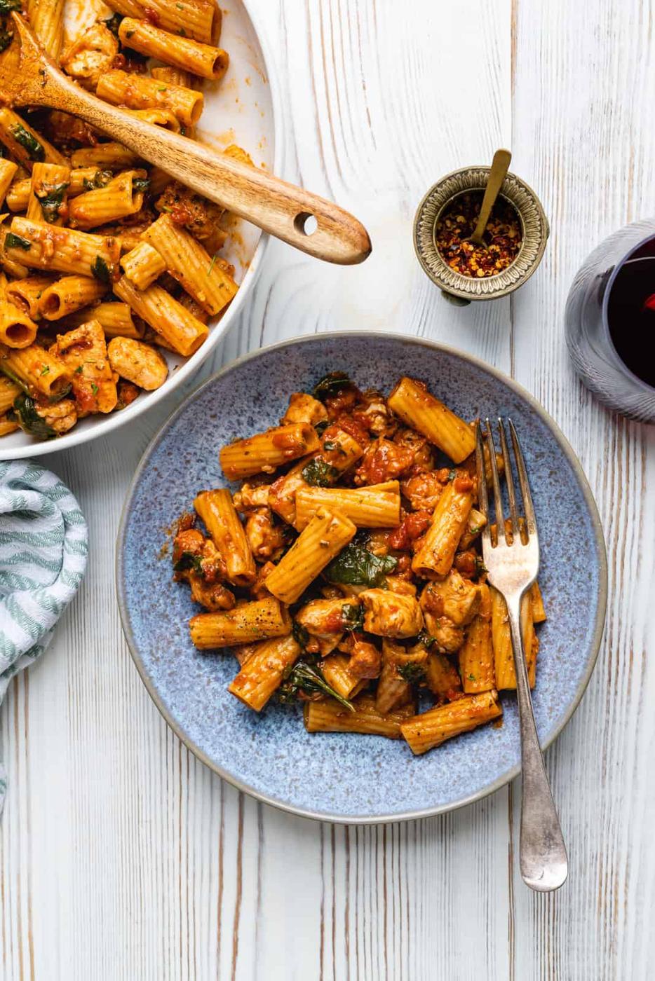 Serving of chicken chorizo pasta in a blue bowl