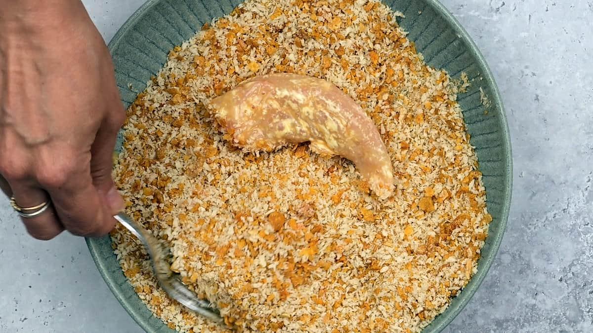 Covering chicken tender with crispy breadcrumbs