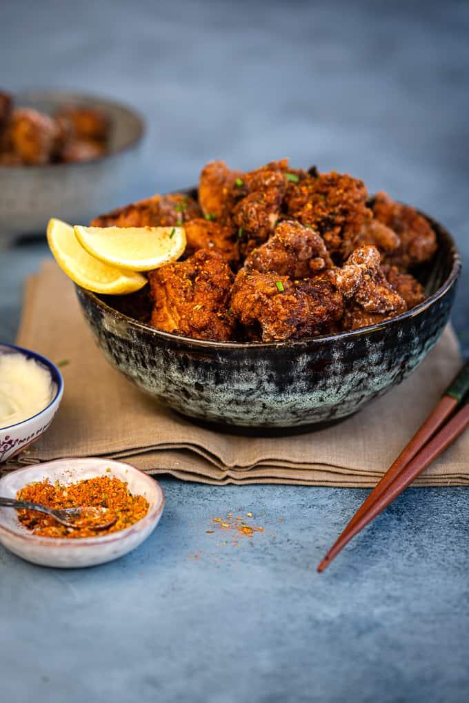 Bowl of Japanese Fried Chicken with lemon wedges and mayonnaise on the side