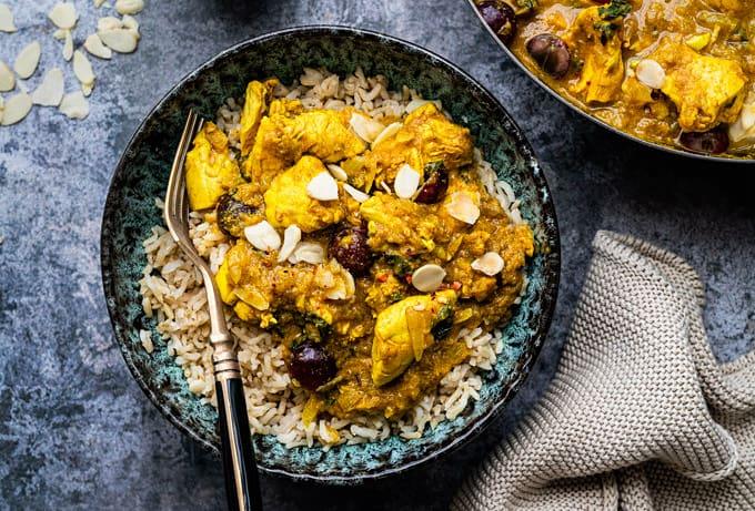 Chicken korma curry served over rice in a bowl