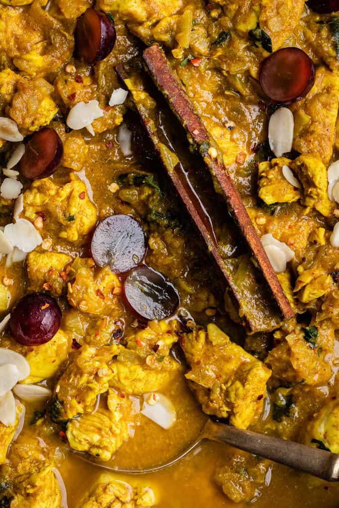 Extreme close up on Slimming World Chicken curry garnished with grapes and almonds