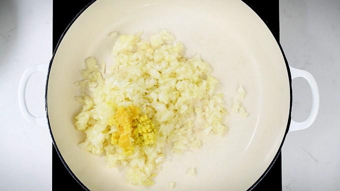 Frying onions garlic and ginger in a pan for chicken curry