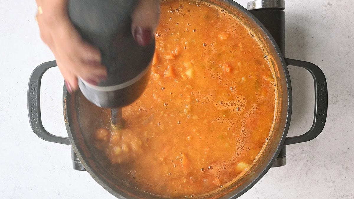 blending soup with an immersion blender