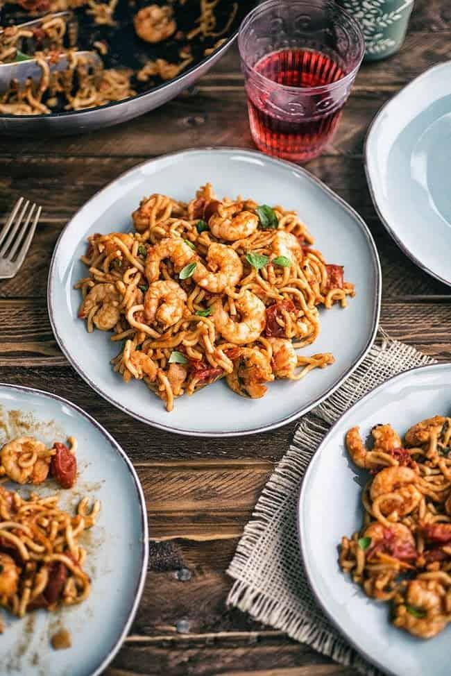 Table set with three plates of Chilli Prawn Noodles