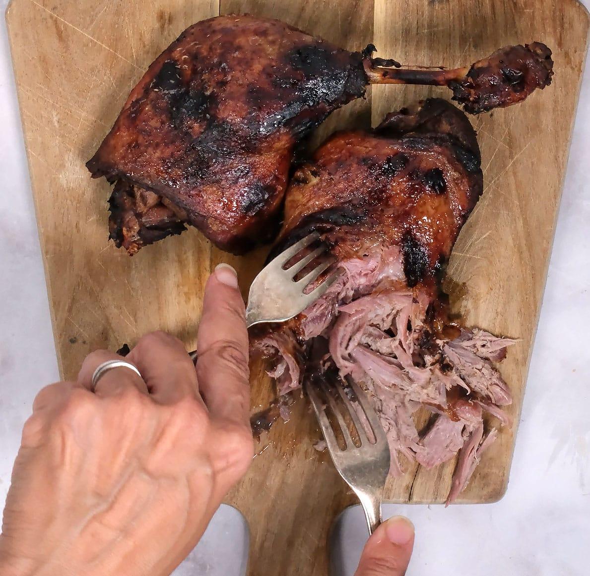 shredding crispy duck using two forks