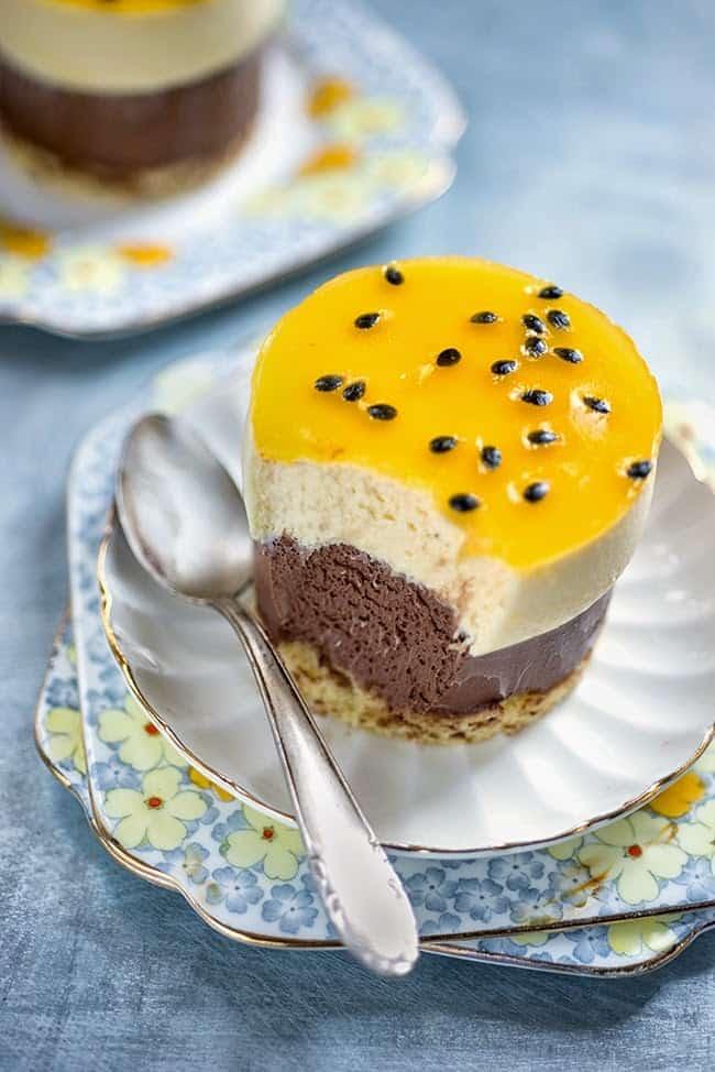 Layered chocolate passionfruit entremet dessert with chocolate and white chocolate layered mousse and passion fruit mirror glaze