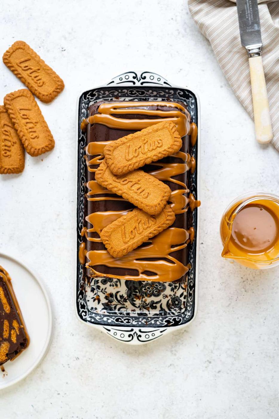 overhead view of chocolate biscuit cake decorated with Biscoff spread and cookies