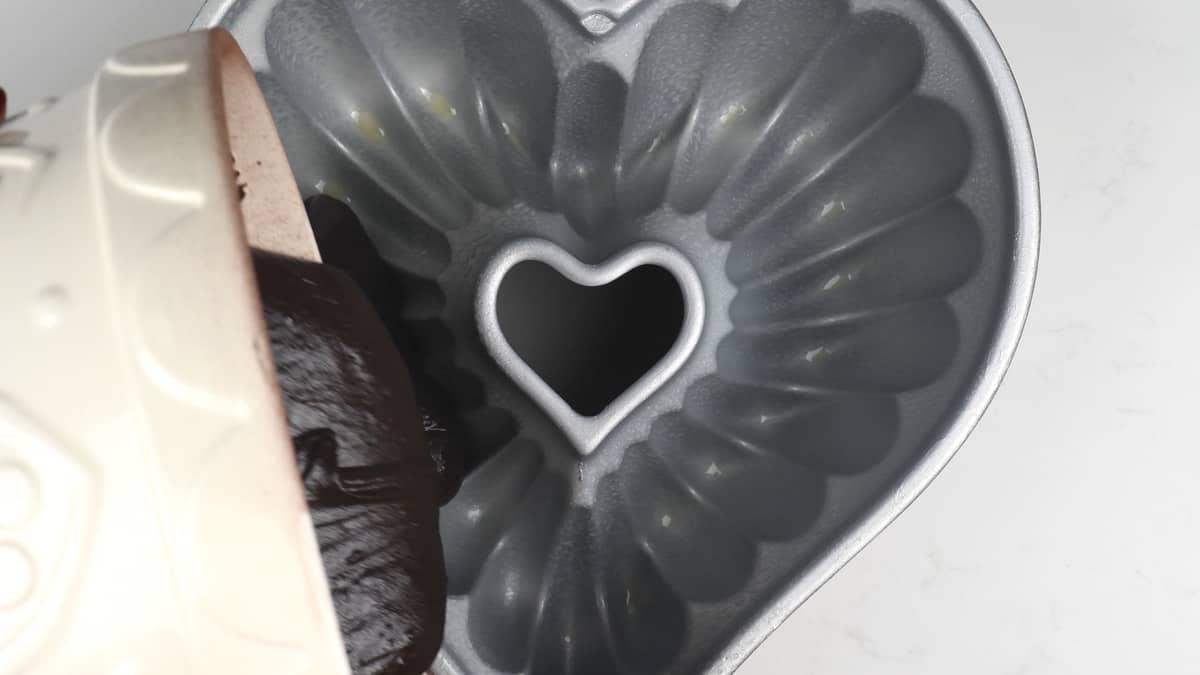 Adding batter into bundt tin for chocolate cake