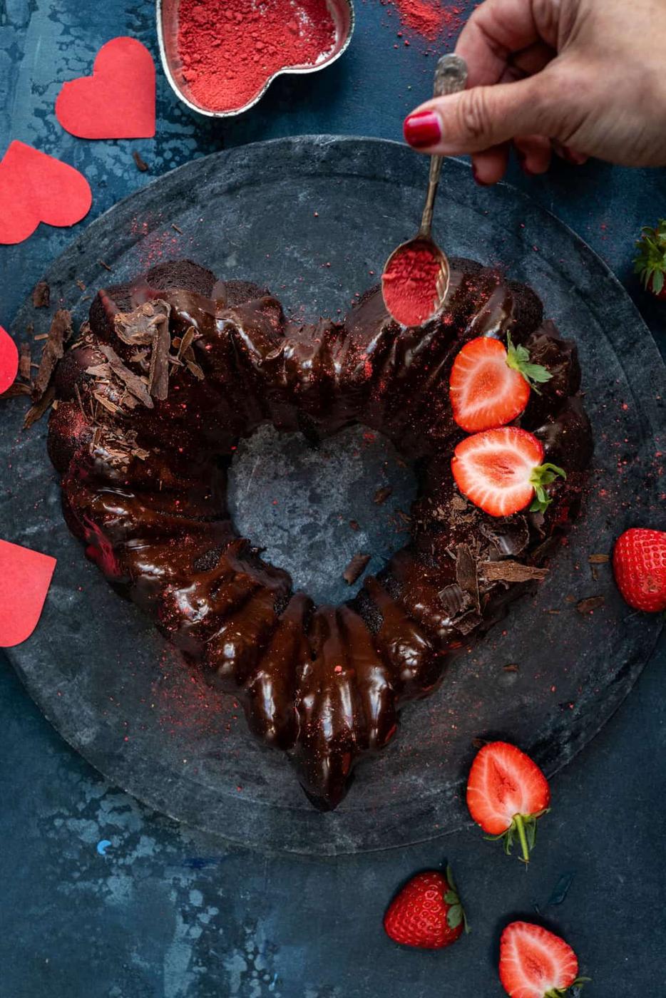 Adding decorations to a vegan chocolate bundt cake