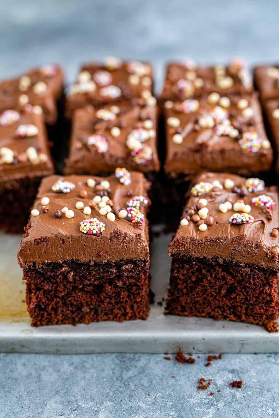 Chocolate cake with sprinkles on a baking sheet.