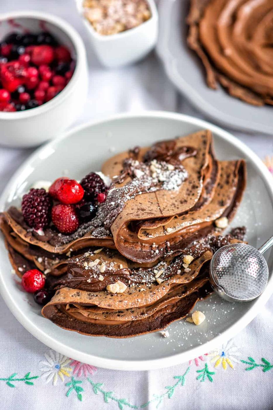 Chocolate crepes filled with Nutella and drizzled with chocolate syrup