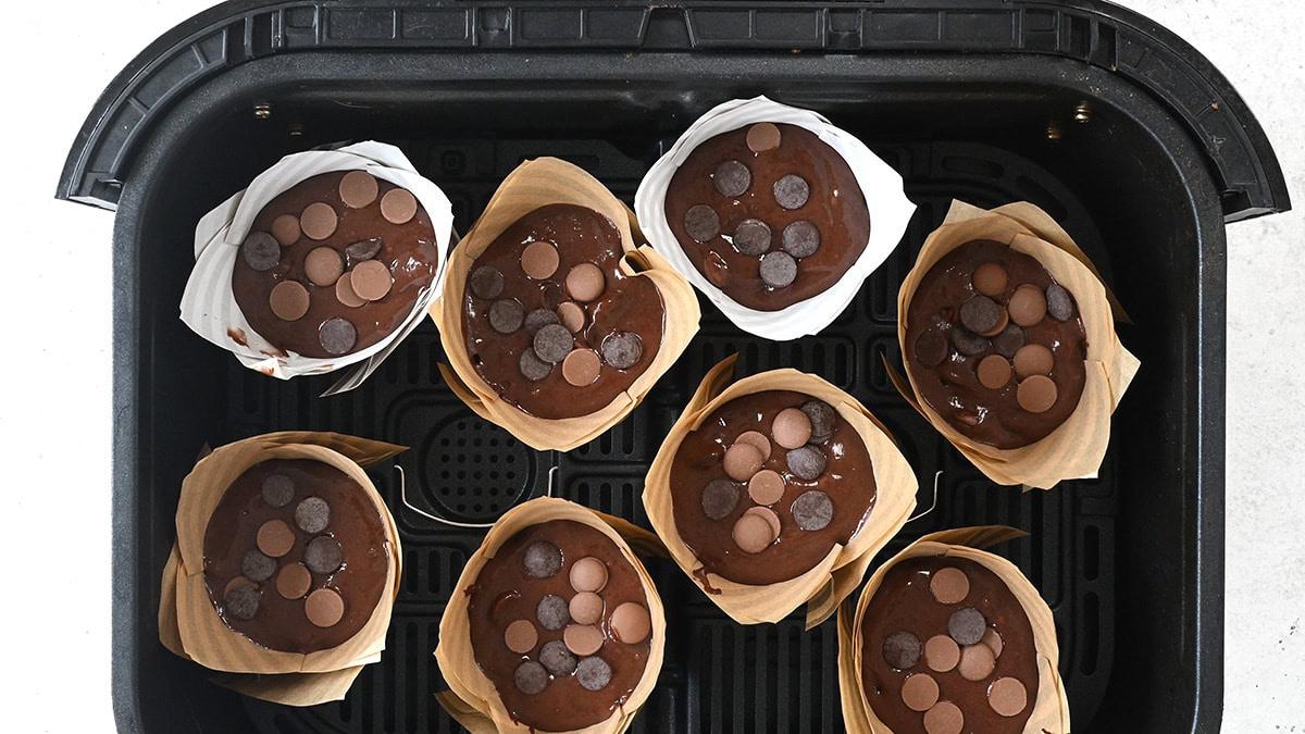 Chocolate muffins in the basket of an air fryer prior to baking