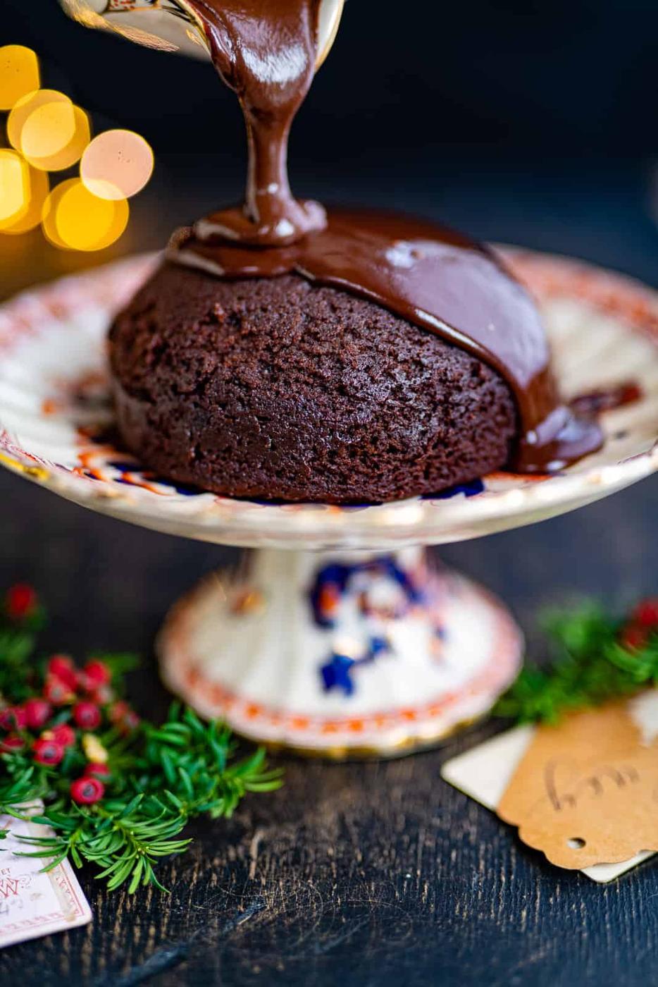 Steamed Chocolate Pudding being drizzled with chocolate sauce