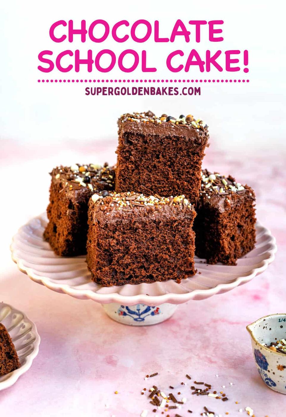 four slices of chocolate cake with buttercream frosting and sprinkles on cake stand