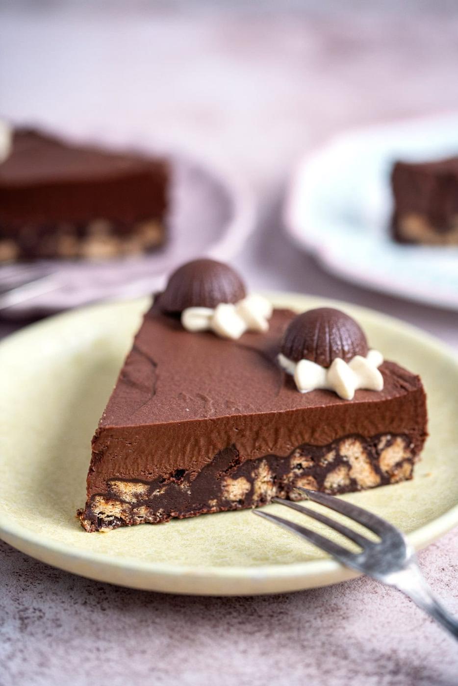 slice of chocolate truffle tart on a yellow plate