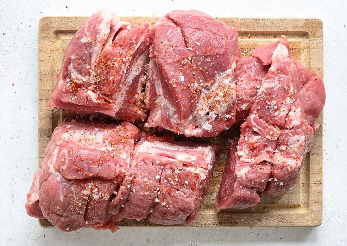pieces of pork shoulder on a cutting board
