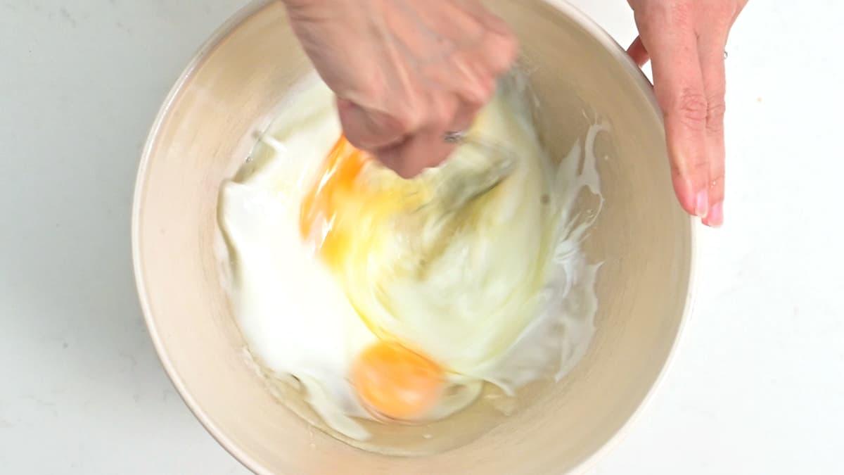 whisking eggs, oil and buttermilk in a bowl