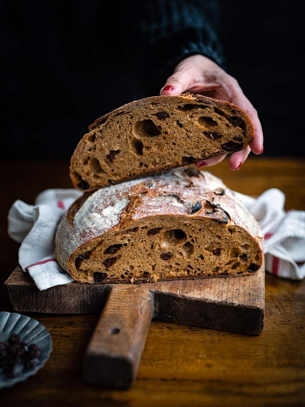 Cinnamon raisin sourdough loaf sliced in half to show the bread texture
