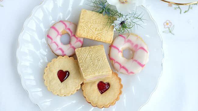 Table set with plates of homemade classic British biscuits and cups of tea
