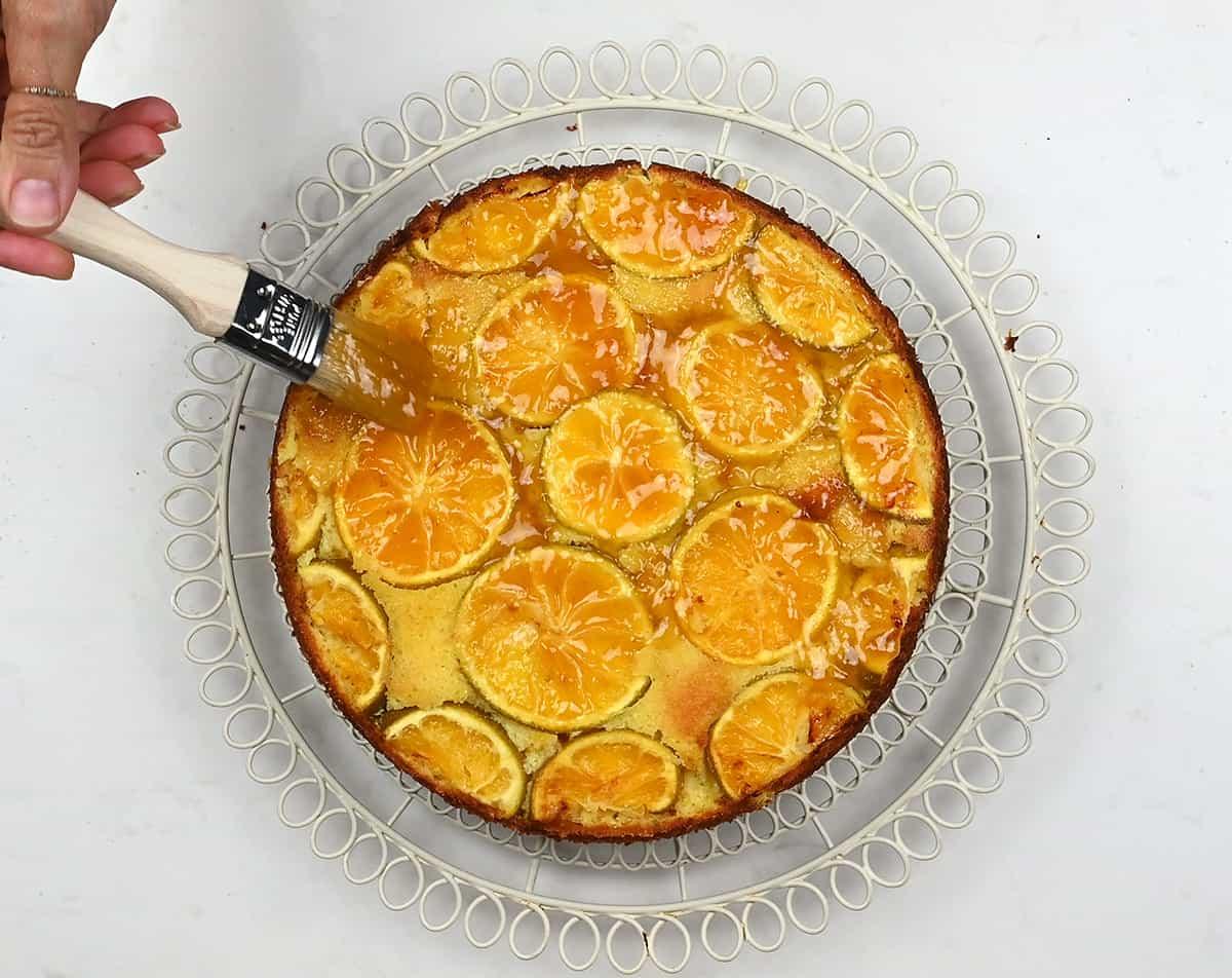 brushing clementine cake with jam