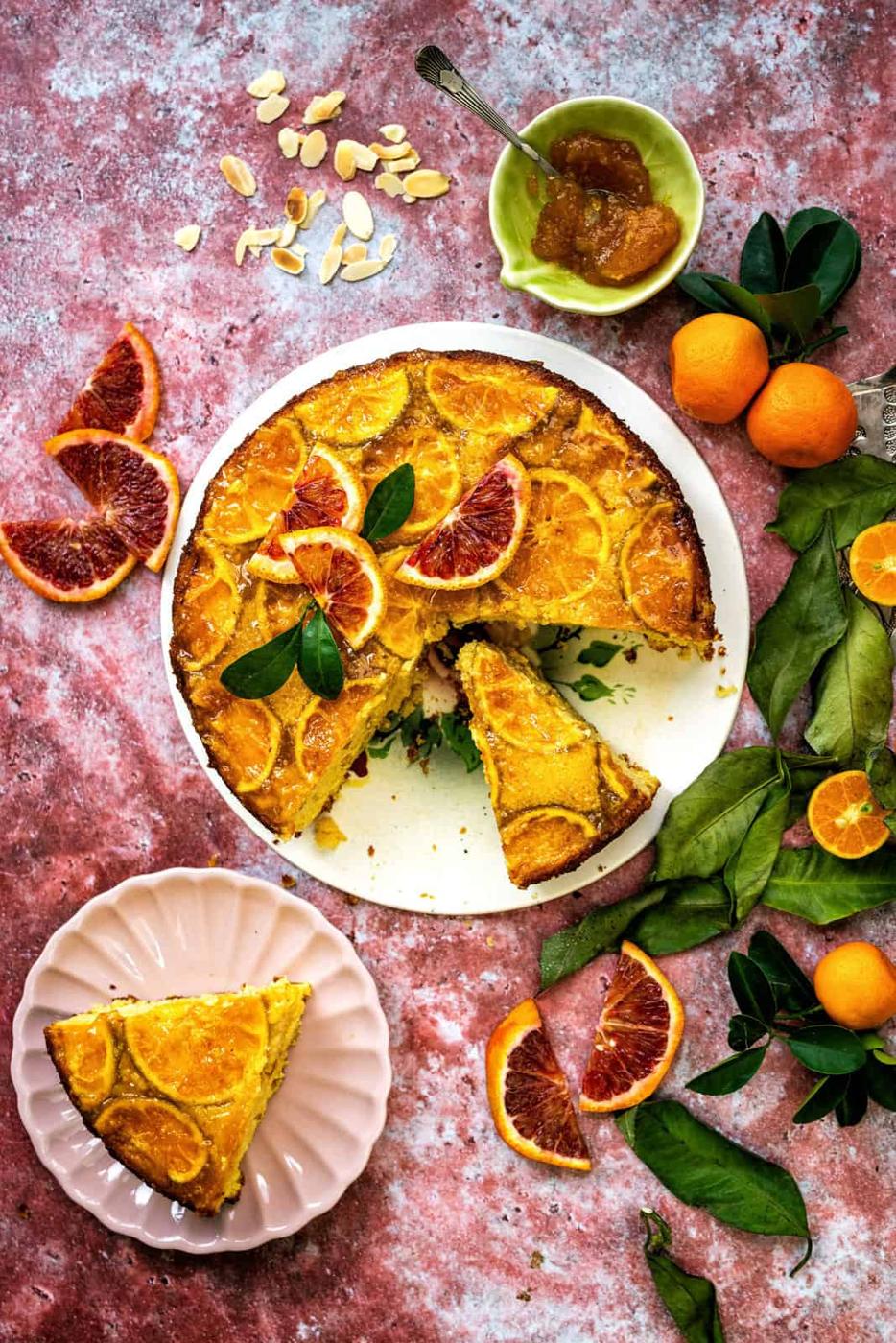 Clementine cake sliced on a pink background