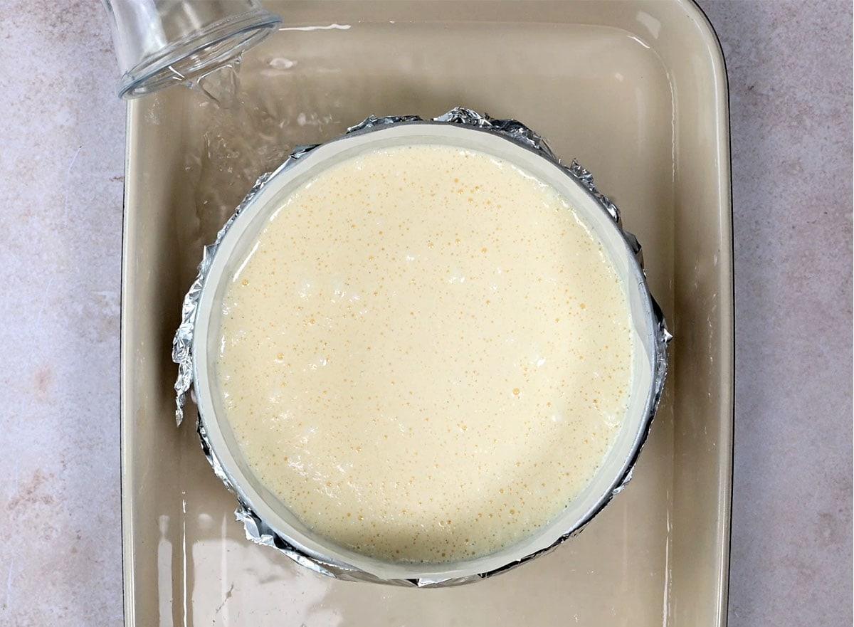 adding water to a water bath to bake cloud cake