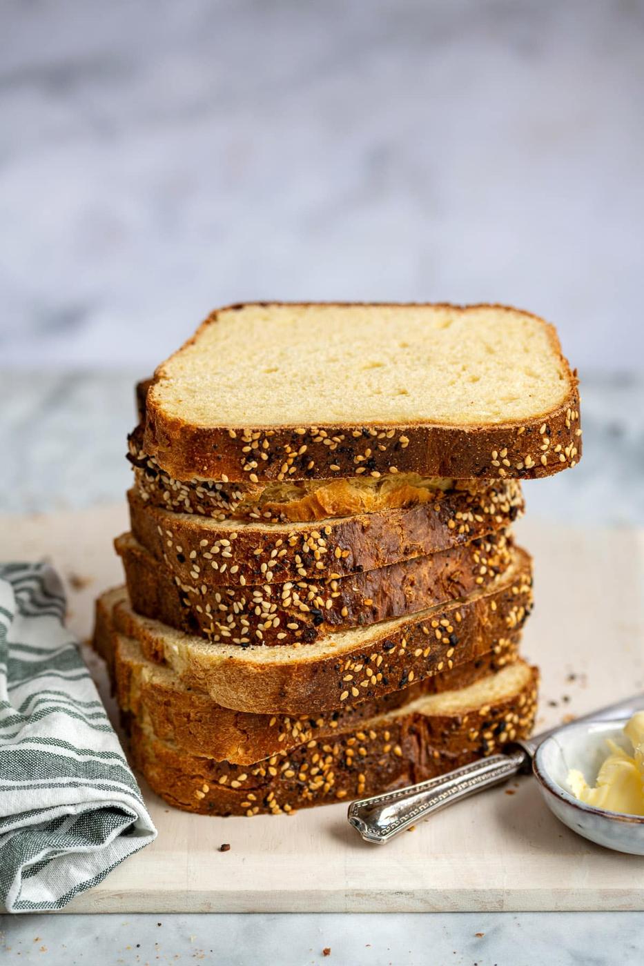 slices of high protein bread made with cottage cheese, stacked, on a cutting board