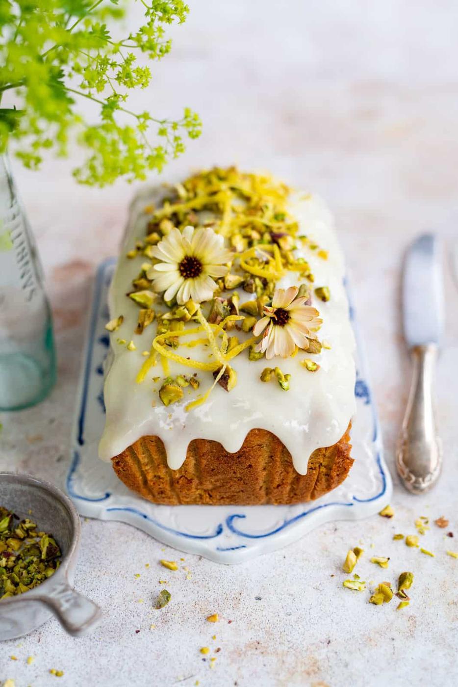 Zucchini Loaf Cake with glaze on a ceramic board