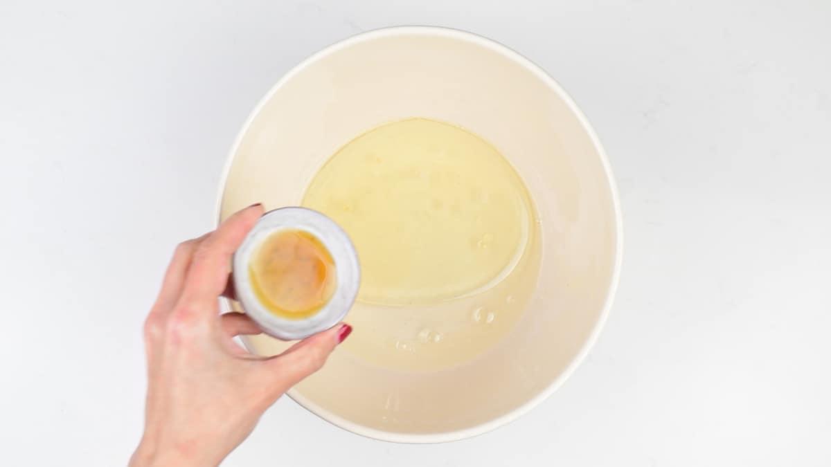 Liquid ingredients for wacky cake in a large mixing bowl