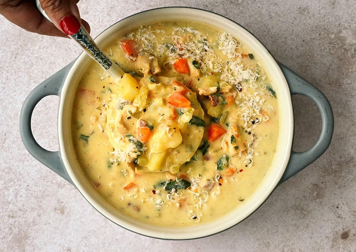 pot of chicken potato soup, ladle in the pot