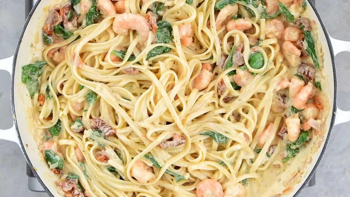 Add the linguine into the Tuscan shrimp