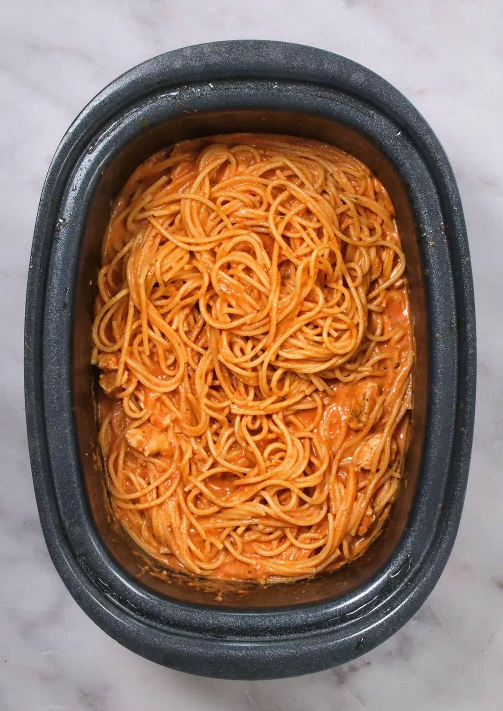 Spaghetti in a creamy tomato sauce in a crock pot