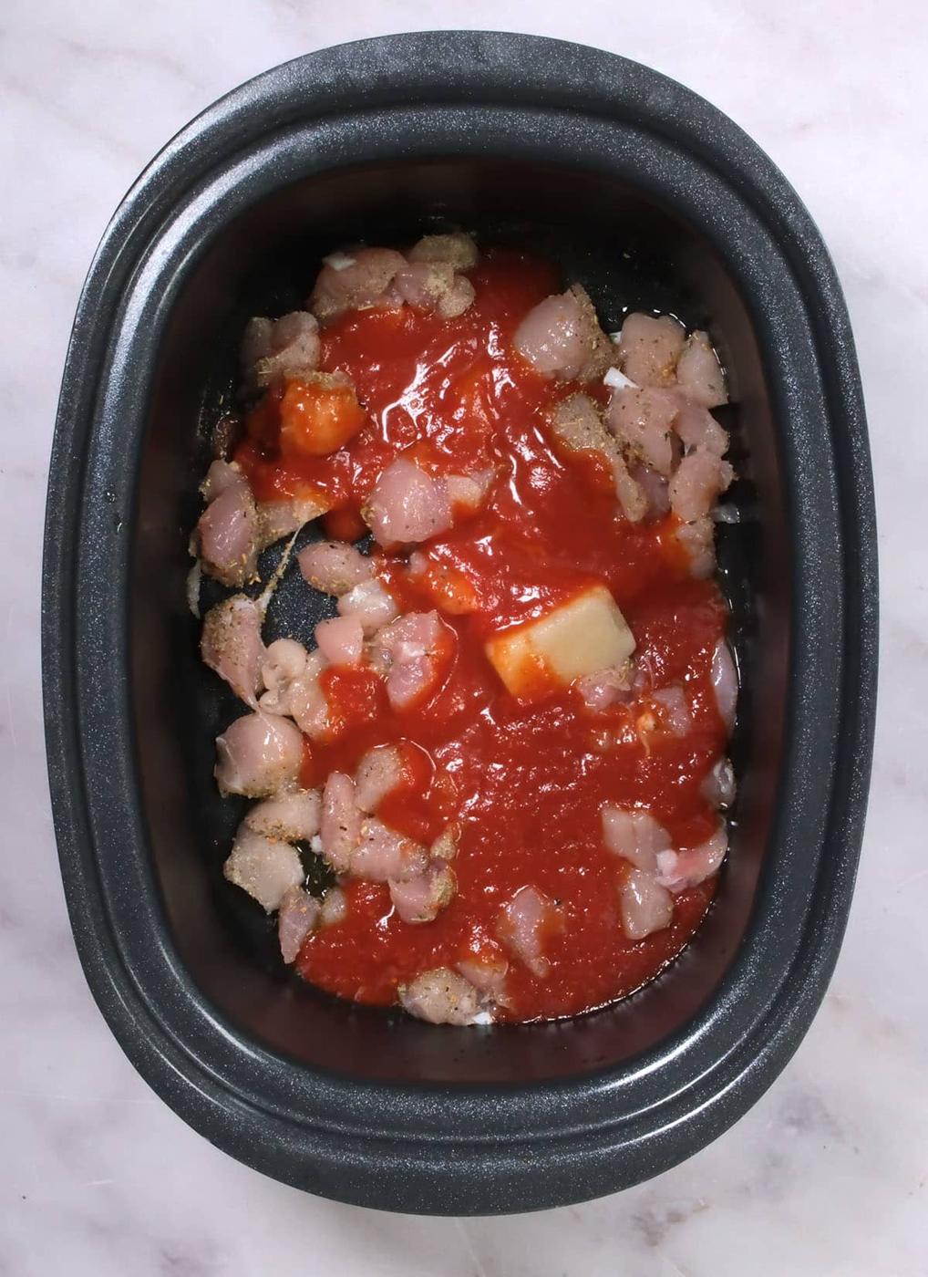Diced chicken breasts and marinara sauce in a crockpot