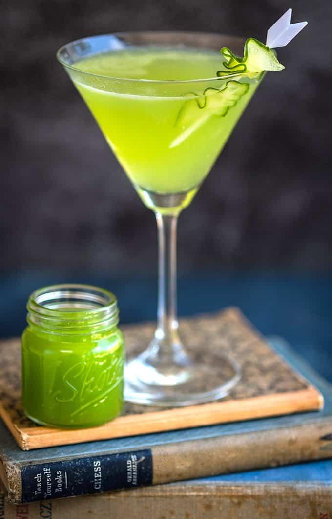 Cucumber Gin Martini in a martini glass balanced on a stack of books